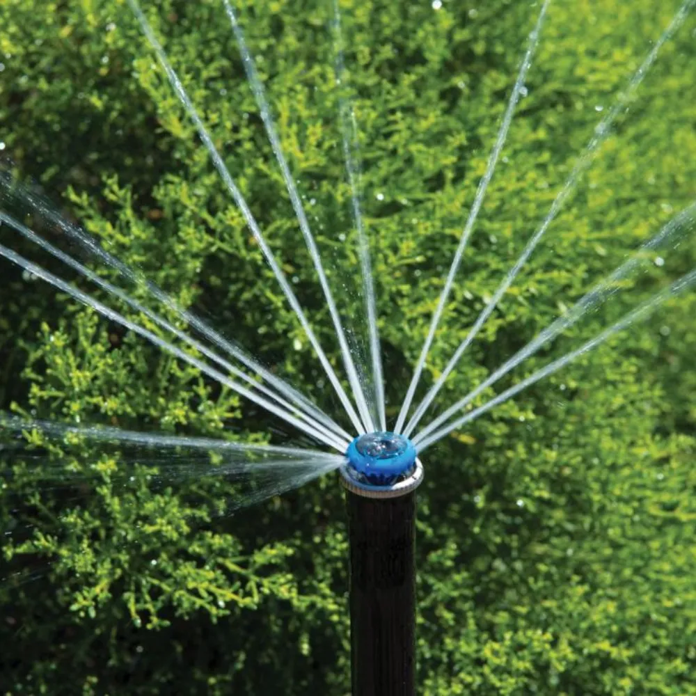 An ST Systems rotor sprinkler spraying water outdoors